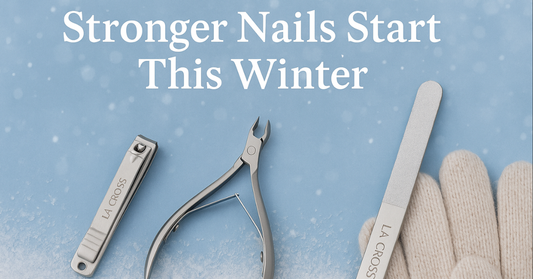 Winter-themed banner showing La Cross stainless steel nail tools—a nail clipper, cuticle nipper, and nail file—arranged on a snowy blue background with cozy gloves, alongside the text ‘Stronger Nails Start This Winter