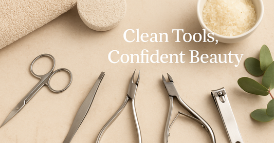 Aesthetic flat lay of La Cross stainless-steel grooming tools — scissors, tweezers, cuticle nippers, and nail clippers — arranged neatly on a beige spa surface with towel, bath salts, and eucalyptus leaves beside the text ‘Clean Tools, Confident Beauty.’