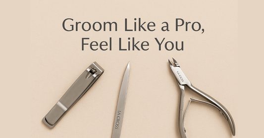 A flat-lay of La Cross stainless-steel beauty tools — nail clippers, tweezers, and cuticle nippers — arranged on a soft neutral background symbolizing clean, professional grooming.