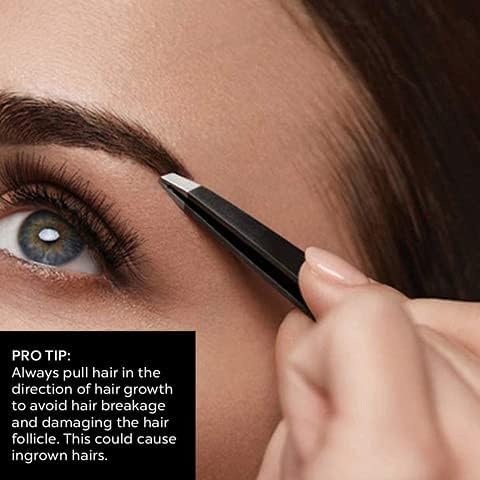 Woman using La Cross Expert Slant Tip Tweezer in front of mirror for eyebrow grooming in a bright bathroom setting