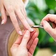 Person using La Cross Cuticle Nipper during a manicure to trim cuticles outdoors